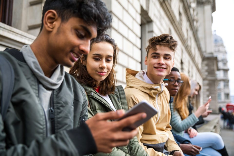 Teenagers students using smartphone on a school break