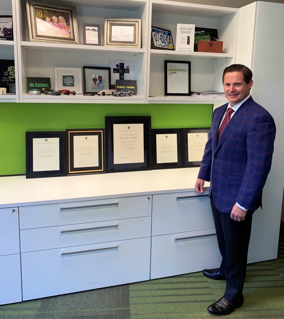 John Paul with an array of certificates from Harvard Business School