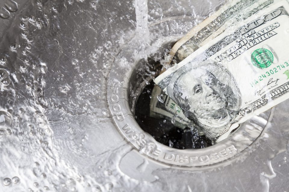 Money being washed down garbage disposal