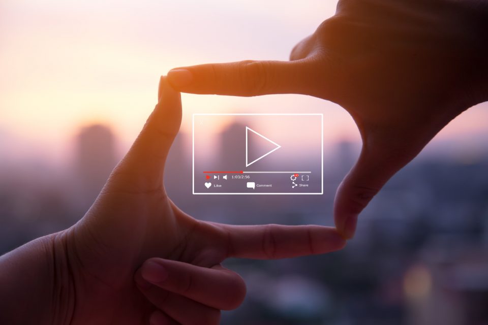 Photo sign made by human hands on blurred sunset sky as background